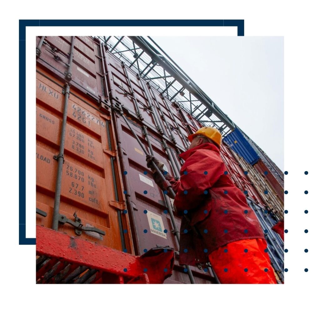person looking up at shipping containers