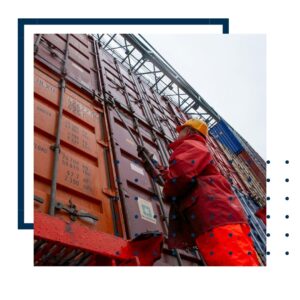 person looking up at shipping containers